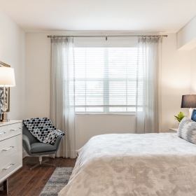 Bedroom with large window & hardwood floor